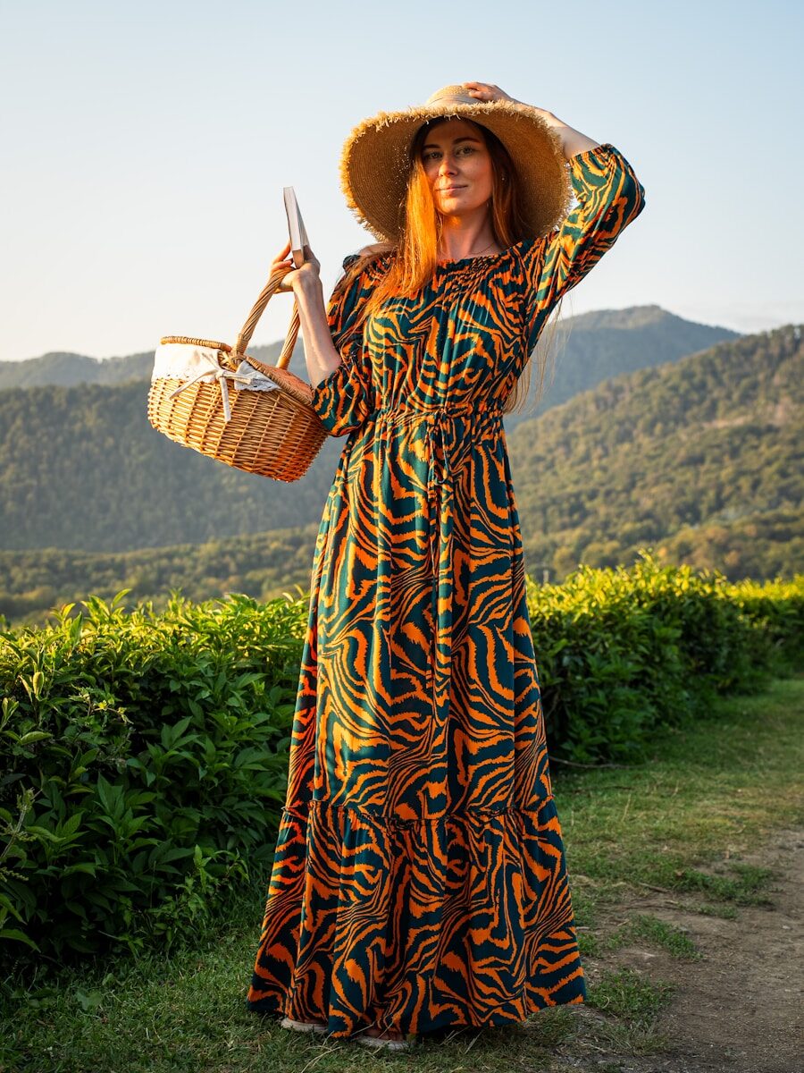Woman in a patterned dress and hat holding a basket