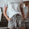 woman in white crew neck t-shirt and black and white striped skirt