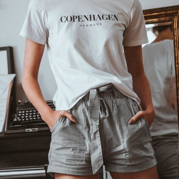 woman in white crew neck t-shirt and black and white striped skirt