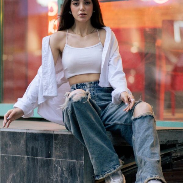 Chic portrait of a young woman in trendy fashion, Tehran cityscape.