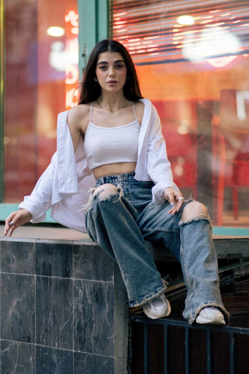 Chic portrait of a young woman in trendy fashion, Tehran cityscape.