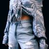 woman in gray and black floral long sleeve shirt and blue denim jeans