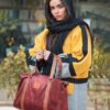 woman in yellow and black hijab and red leather sling bag