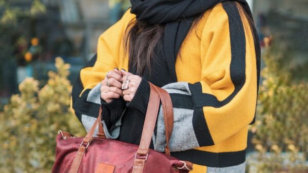 woman in yellow and black hijab and red leather sling bag