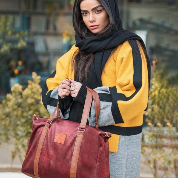 woman in yellow and black hijab and red leather sling bag