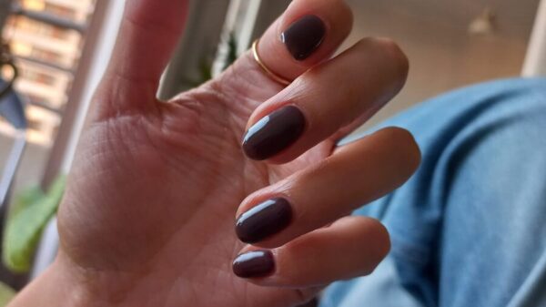 Hand with painted nails and a ring.