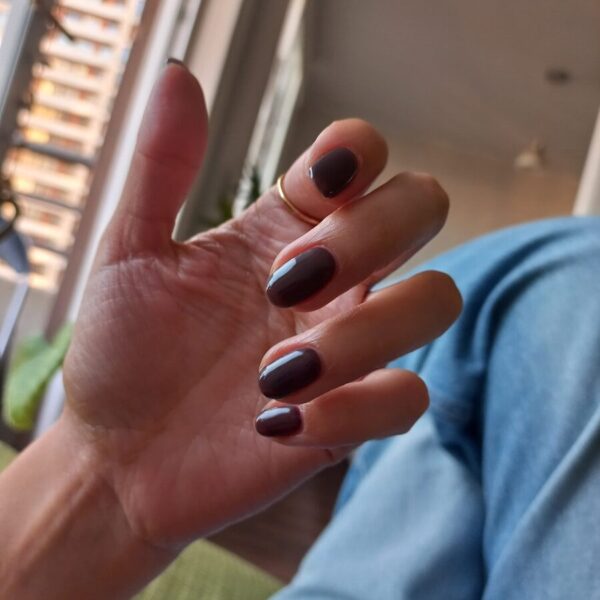 Hand with painted nails and a ring.