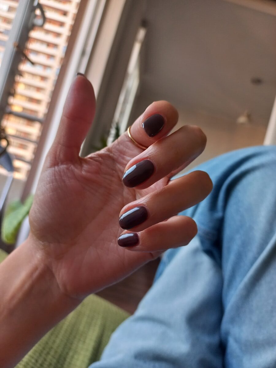Hand with painted nails and a ring.