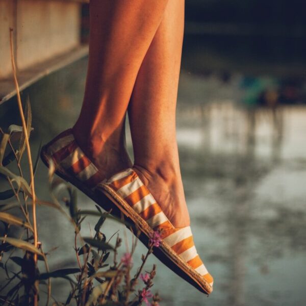 woman in brown leather peep toe heeled sandals
