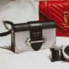 black and silver camera on white textile