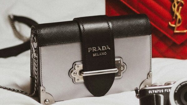 black and silver camera on white textile