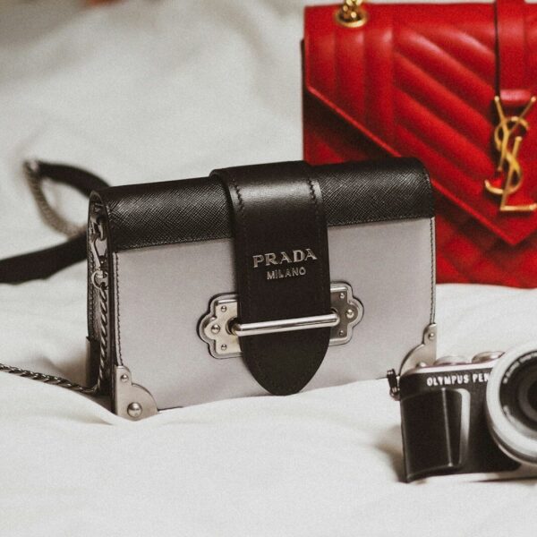 black and silver camera on white textile