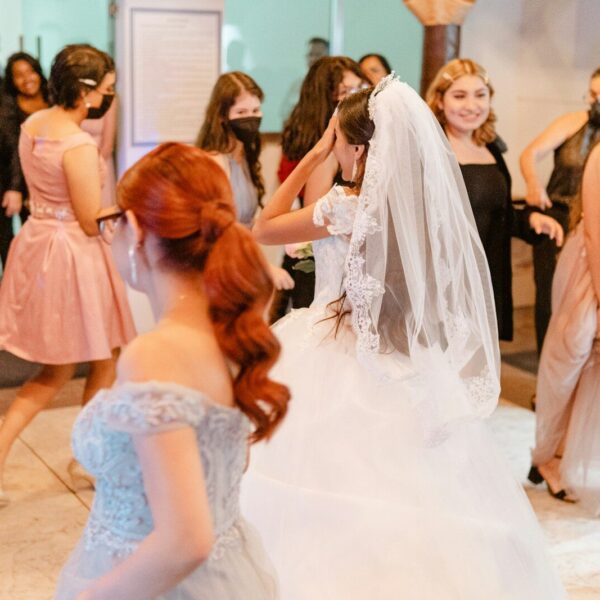 Bride dances with friends at a celebration.
