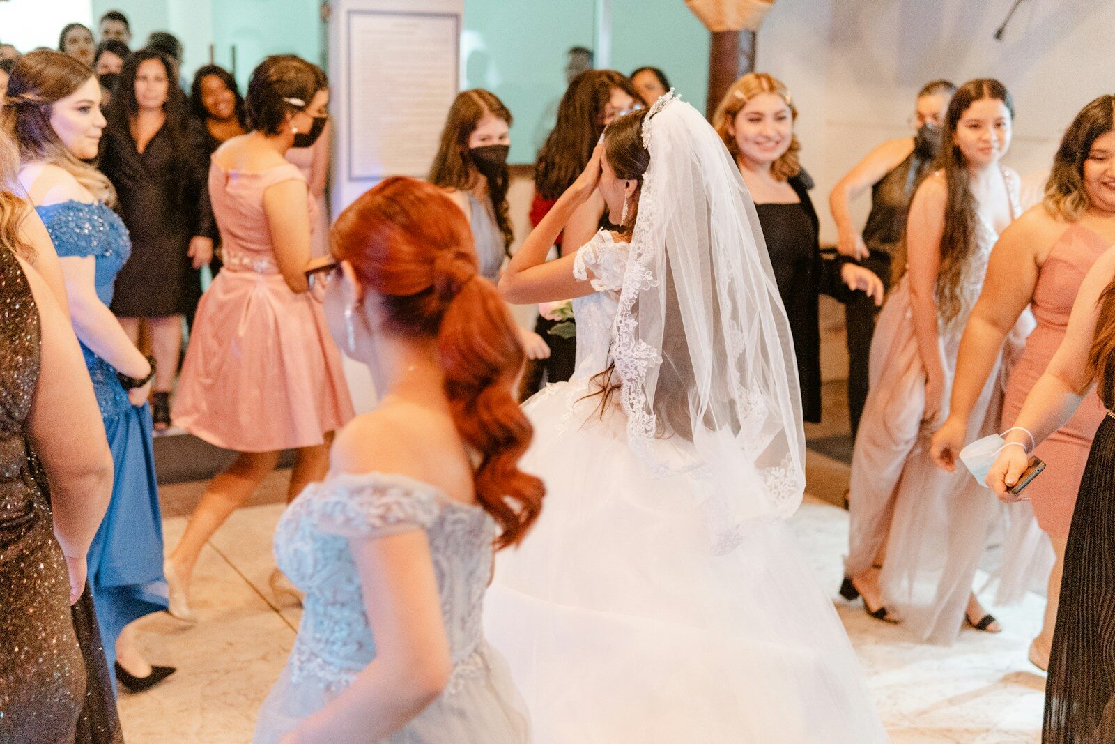 Bride dances with friends at a celebration.