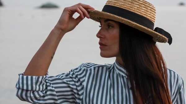 woman in white and blue striped long sleeve shirt wearing brown hat