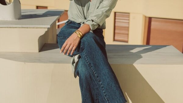a woman sitting on a ledge with her legs crossed