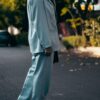 man in gray formal suit standing on gray asphalt road during daytime