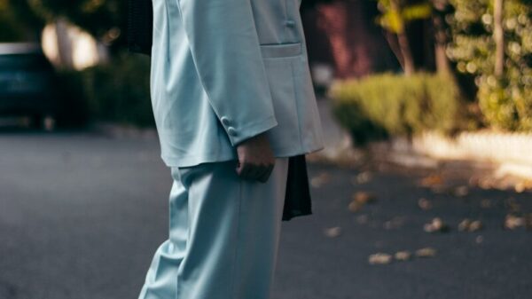 man in gray formal suit standing on gray asphalt road during daytime