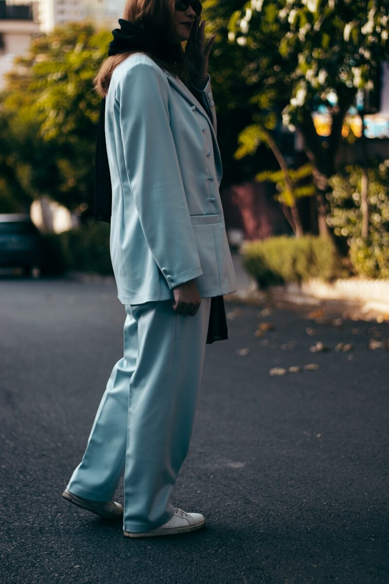 man in gray formal suit standing on gray asphalt road during daytime