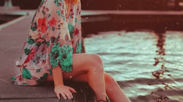 woman sitting near body of water