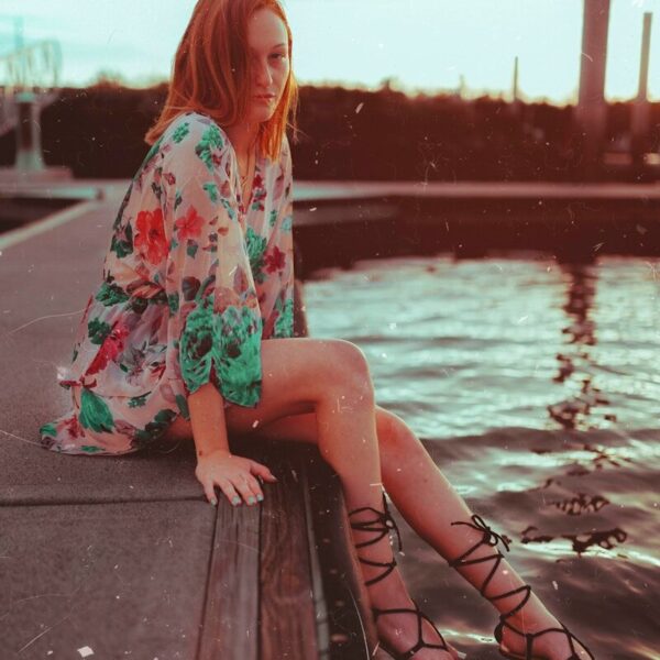 woman sitting near body of water