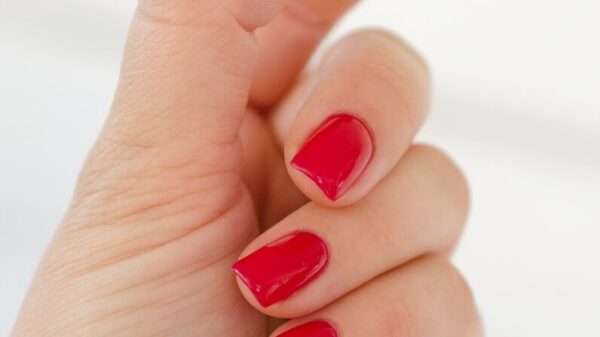 a hand with painted fingernails