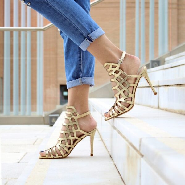 woman wearing brown leather heeled sandals walking on staircase