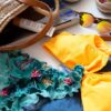 brown and black sunglasses on yellow textile
