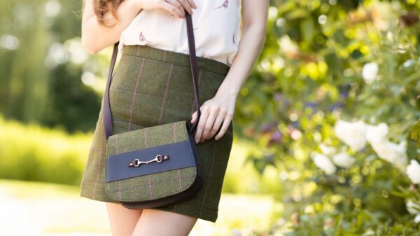 a woman in a skirt holding a purse