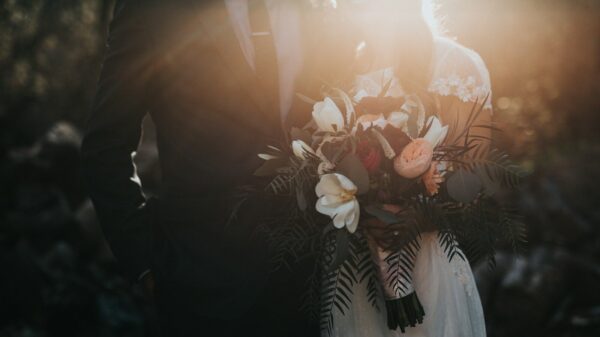 groom beside bride holding bouquet flowers