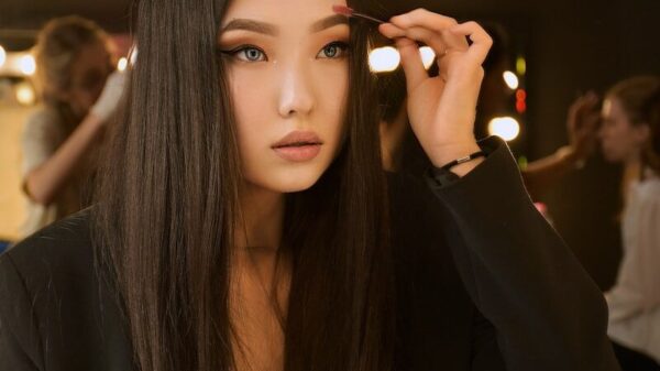woman in black long sleeve shirt holding her hair