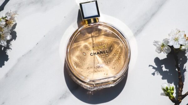 a bottle of perfume sitting on top of a white table