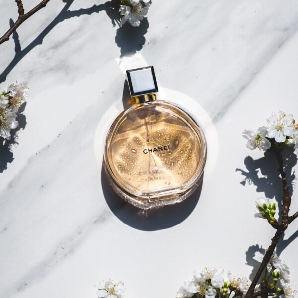 a bottle of perfume sitting on top of a white table