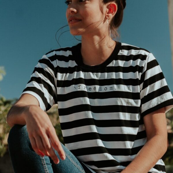 shallow focus photo of woman in white and black striped crew-neck T-shirt