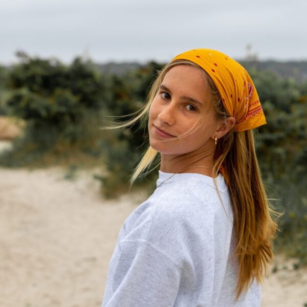 woman in white long sleeve shirt and yellow knit cap