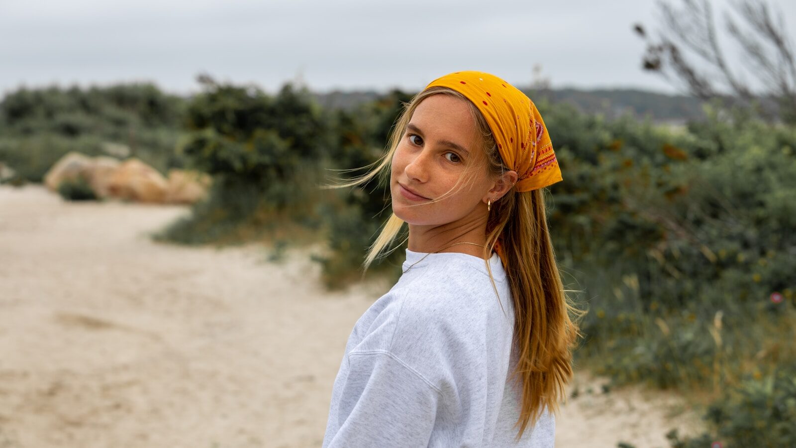 woman in white long sleeve shirt and yellow knit cap