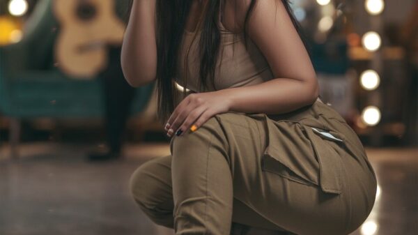 woman in brown sleeveless dress sitting on floor