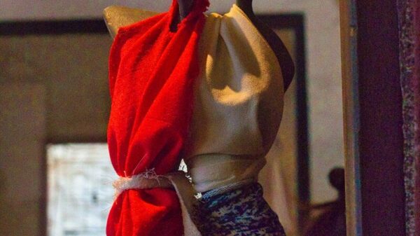 a mannequin with a red scarf wrapped around it