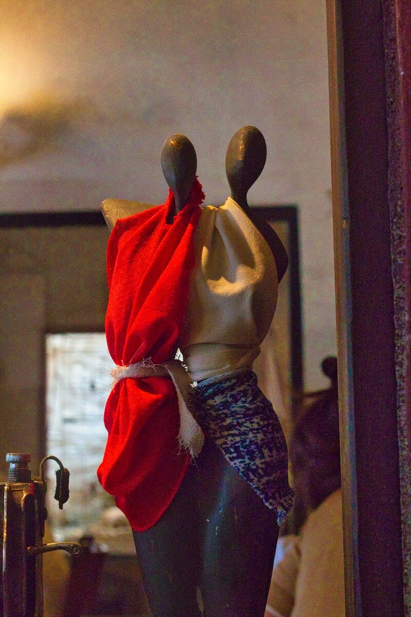 a mannequin with a red scarf wrapped around it
