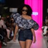 A model struts the runway wearing stylish clothing.