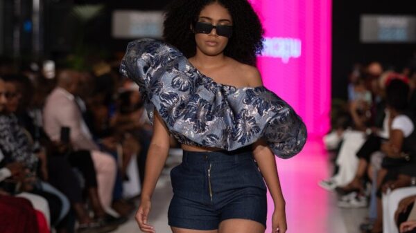 A model struts the runway wearing stylish clothing.