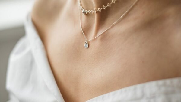 woman in white off shoulder shirt wearing silver necklace