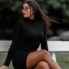 woman in black long sleeve shirt sitting on white wooden bench during daytime