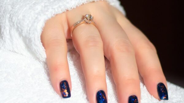 a woman's hand with a blue and white manicure