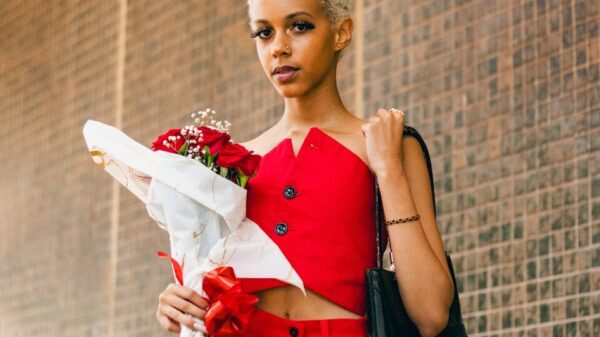 a woman in a red outfit holding a bouquet of flowers