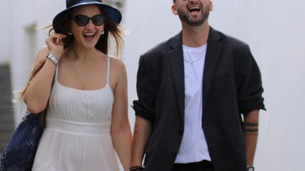 A man and a woman walking down a street