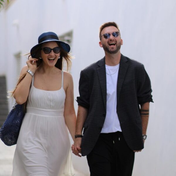 A man and a woman walking down a street