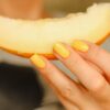 a person holding a slice of cheese