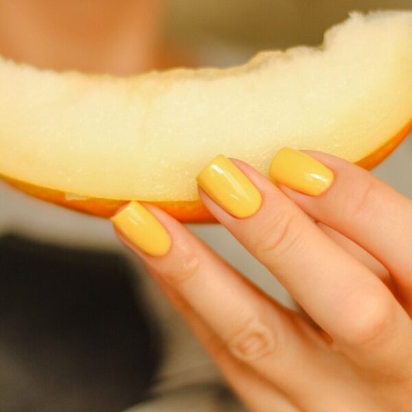 a person holding a slice of cheese
