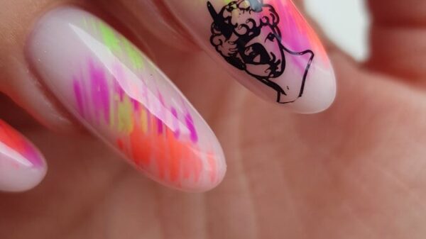 Nails with abstract neon paint and classical bust art.